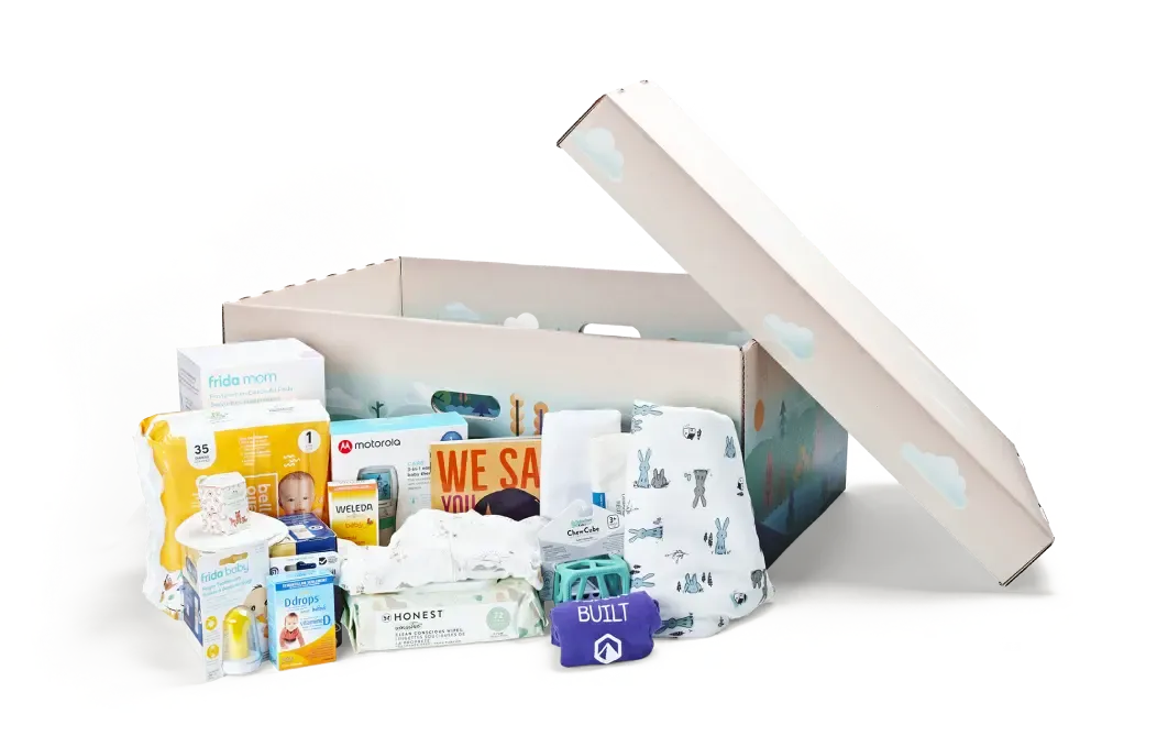 Photograph of the Yukon Baby Basket containing baby care items, including diapers, bottles and clothing.