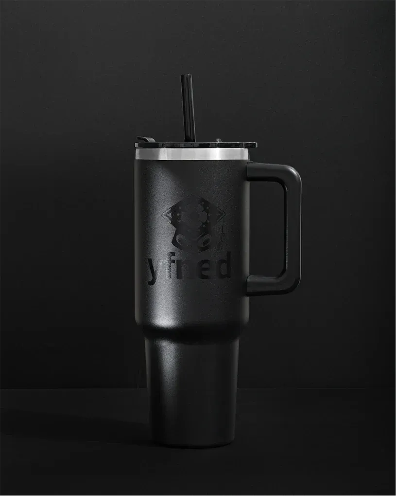 Matte black travel mug with a handle and straw, embossed with the YFNED logo.